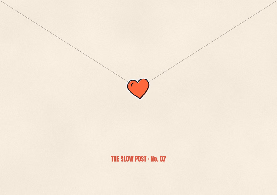 The back of the envelope, its flap sealed with a red heart sticker