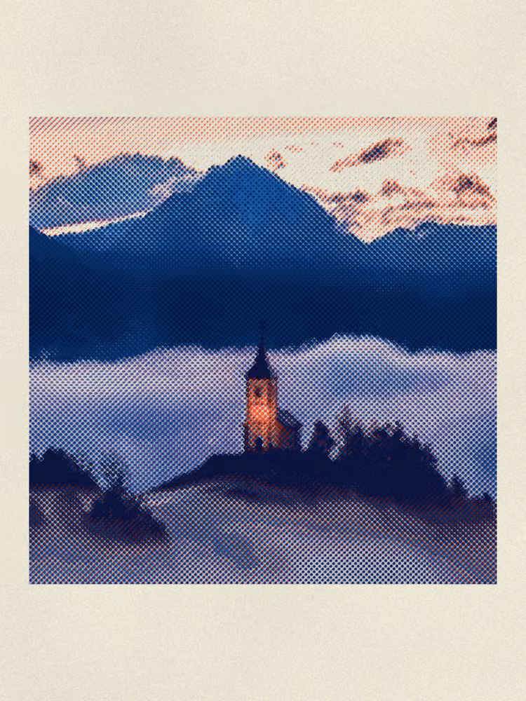 A hilltop church above a sea of cloud at dusk