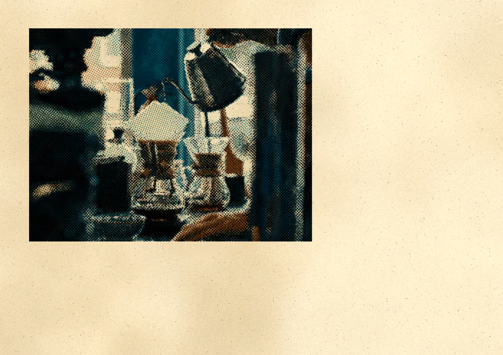 Pour-over coffee on a counter, a small dark print on speckled paper